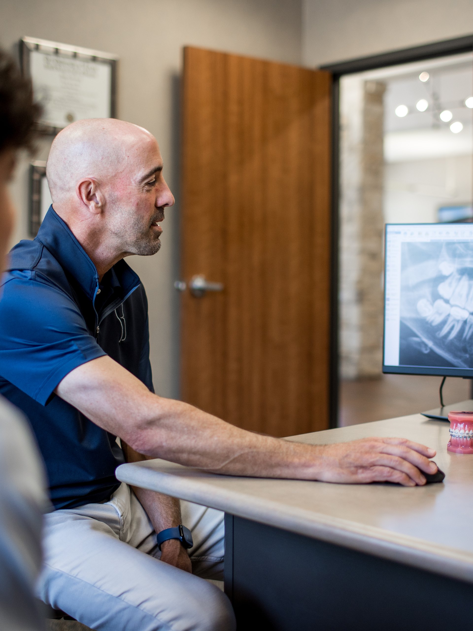 Dr. Sherman reviewing a panoramic X-ray with a patient.