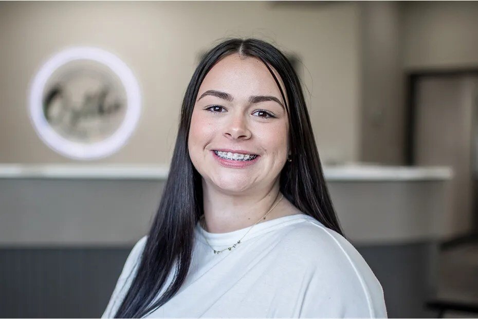 Patient smiling with low-profile Empower clear braces.